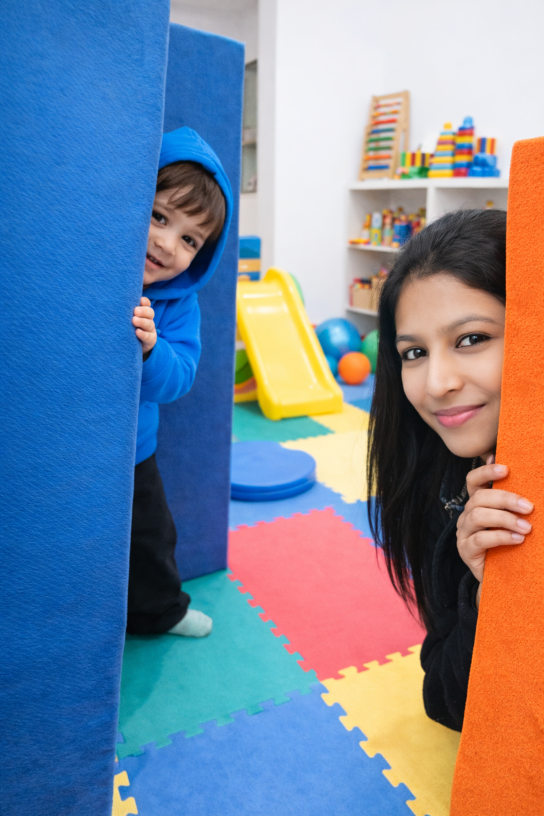 A child and therapist playing hide and seek in therapy session